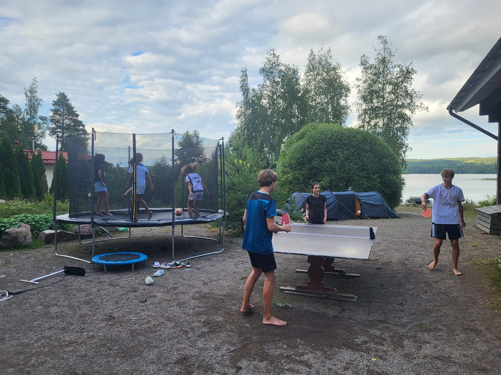 Children playing games in the cottage yard on a summer evening