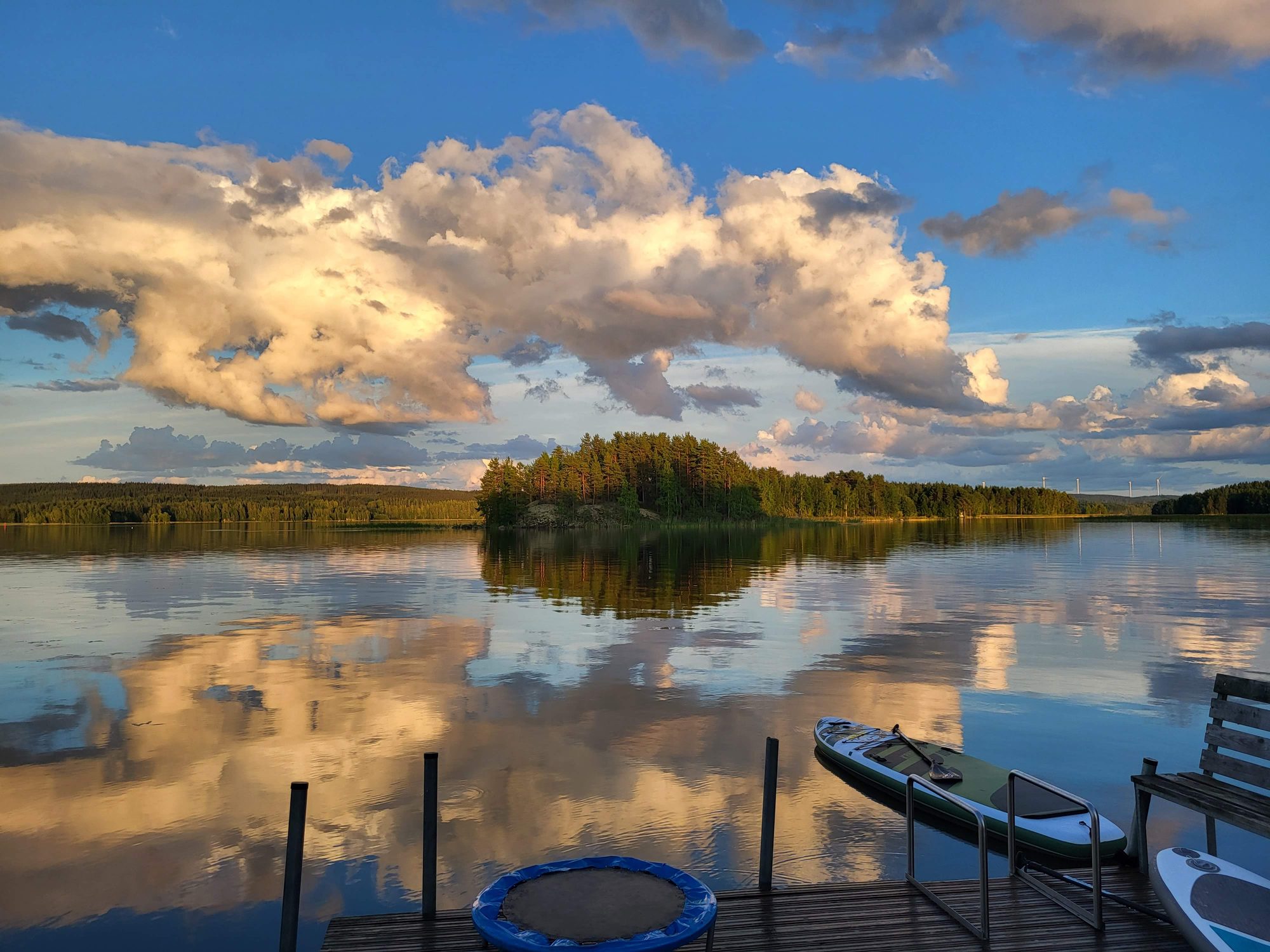 Finnish lake at dusk with dramatic clouds reflected in still water