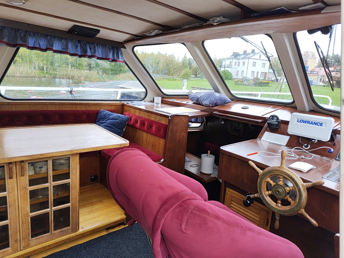 Holzverkleideter Salon im Boot mit Sitzecke, Tisch und Seeblick