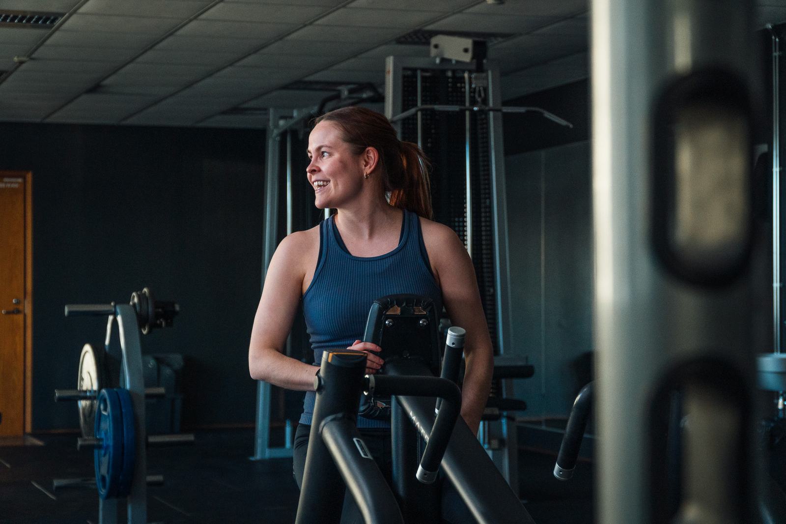 Guest training on a modern cardio machine in the hotel gym